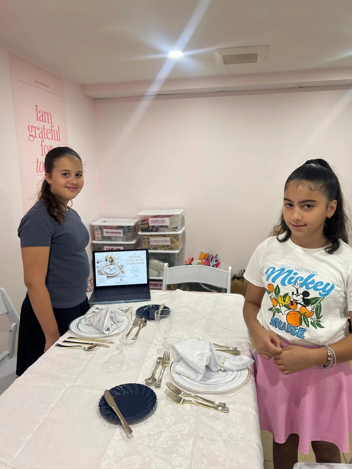 Students practice dining etiquette at a table